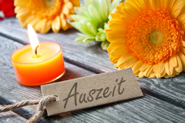 German time out label flowers and candle background